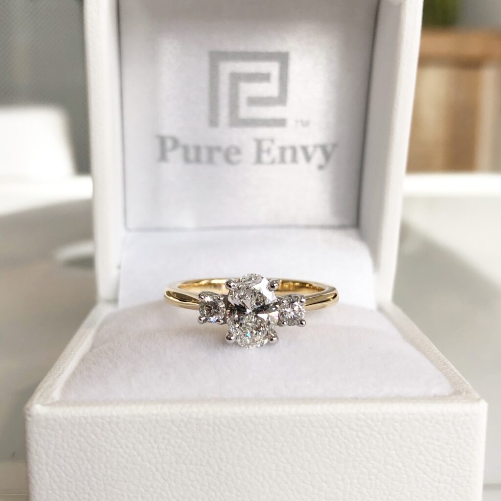oval and round trilogy engagement ring by pure envy